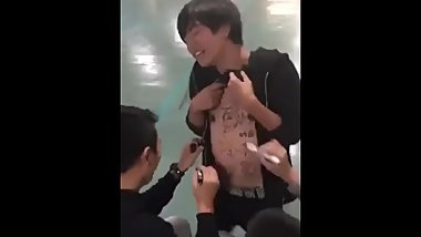 Asian boy heas friend in public