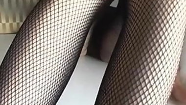 Japanese leg model does a footjob with a plastic cock.